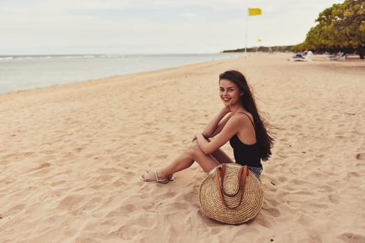 beauty woman sitting smile nature beautiful tan beach carefree sea attractive pretty body travel sand model freedom vacation ocean relax view back