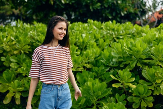 grass woman park freedom beautiful t-shirt smiling young happiness walk lifestyle meadow striped bali hat nature sun summer joy enjoy bag