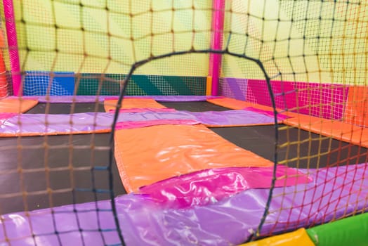 Indoor children's playground in the amusement park with colored balls to play / Inside the beautiful children's playground colored plastic ball of the game room.