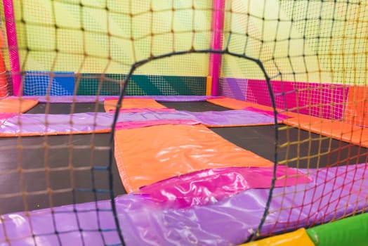 Indoor children's playground in the amusement park with colored balls to play / Inside the beautiful children's playground colored plastic ball of the game room.