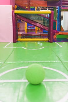 Indoor children's playground in the amusement park with colored balls to play / Inside the beautiful children's playground colored plastic ball of the game room.