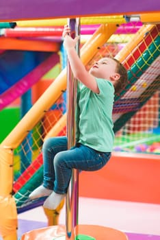 boy on the playground with colored plastic balls.