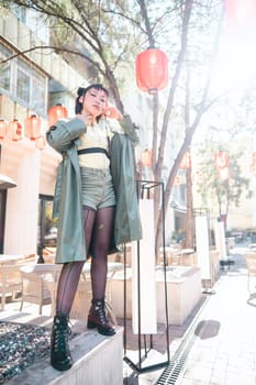 Full length portrait of Asian woman in front of Chinese lanterns