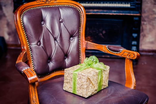 Wrapped gift boxes with ribbons as Christmas presents on a chair