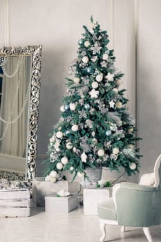 Beautiful holdiay decorated room with Christmas tree with presents under it