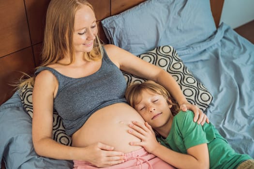 Young beautiful pregnant woman and eldest son. The cute boy leaned his ear against his mother's belly. Expecting a baby in the family concept. Preparing an older child for a younger one.