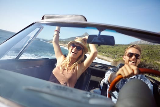 Car road trip, travel and happy couple on ocean holiday adventure, transportation journey or fun summer vacation. Love bond, convertible automobile and driver driving on Australia countryside tour.