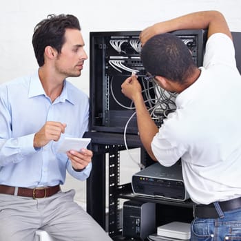 Server room, businessman or electrician fixing cables for maintenance after digital glitch in office. Network, hardware or worker with a technician or electrical engineer for information technology.