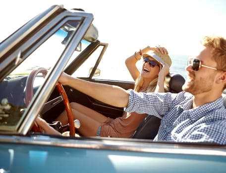 Car road trip, travel and happy couple laughing on holiday bond adventure, transportation journey or fun summer vacation. Love flare, convertible vehicle and driver driving on Canada countryside tour.