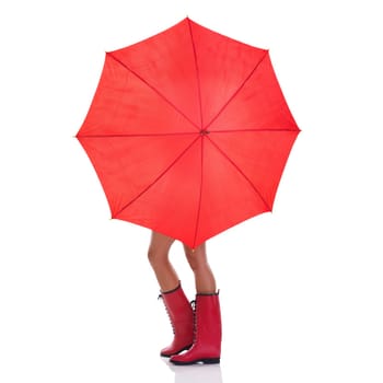 Cover, weather and woman holding a red umbrella, wearing gumboots and girl isolated against a white studio background. Female person, lady and model with insurance, protection and winter outfit.