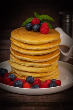 Recipe for maple syrup pancakes with raspberry and blueberry filling, High quality photo
