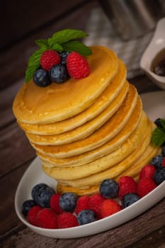 Recipe for maple syrup pancakes with raspberry and blueberry filling, High quality photo