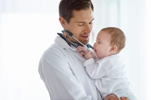 Man, pediatrician and baby playing with stethoscope for medical assessment, support or healthcare of children. Cute newborn, doctor and pediatrics in clinic, kids hospital and trust of expert mockup.