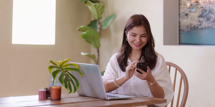 Attractive Asian woman resting comfortable living room and using mobile phone, Relax, Lifestyle.