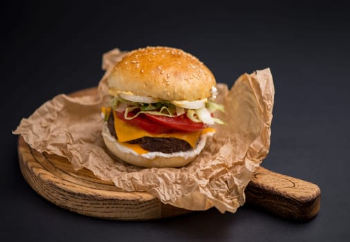 Big tasty burger with beef cutlet on a black