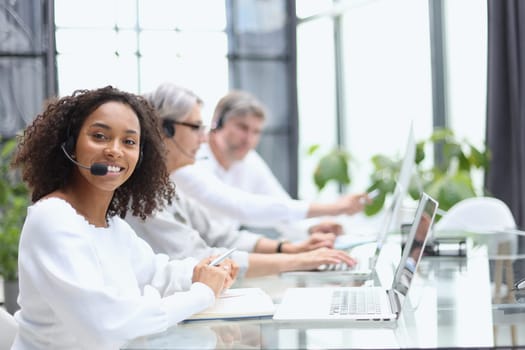 african american operator smiling in a call center.