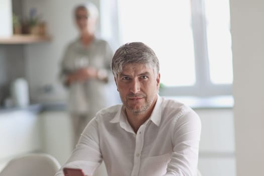 successful businessman holding a phone in his hand in the office