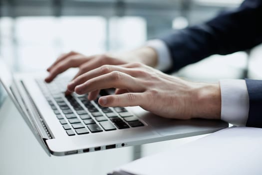 Young man working on computer at table in office, closeup. Banner design