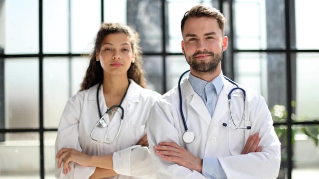 female doctor and male doctor stand in the lobby of the hospital