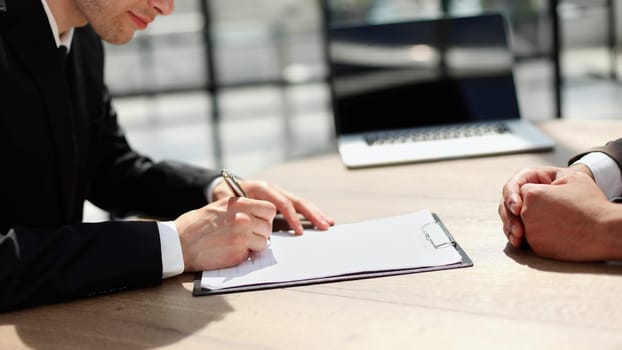 Businessmen hand's pointing where to sign a contract, legal papers or application form.