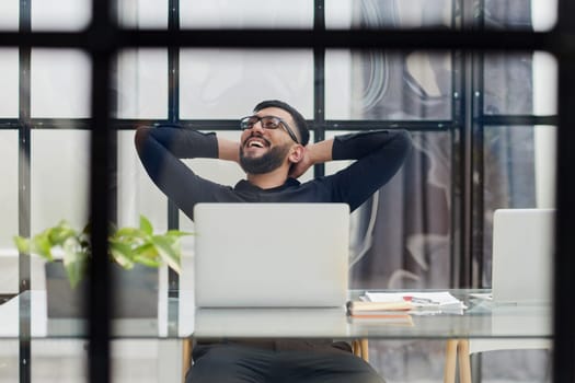 Middle-aged man working on laptop in office
