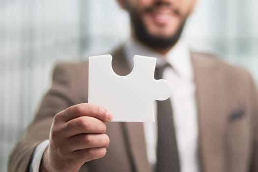People holds in hand a jigsaw puzzle. Business solutions, success and strategy.