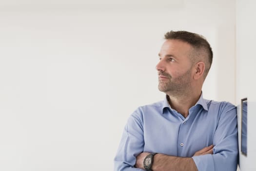 casual older with beard businessman wearing formal business clothes smiling at camera with crossed hands isolated over gray background. High quality photo