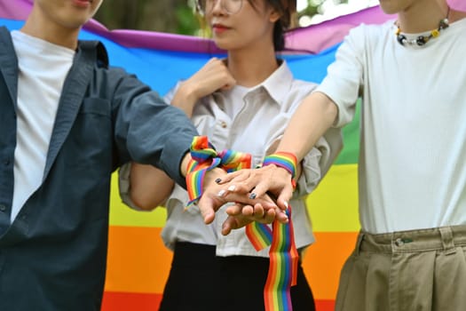 Group of young people stacking hands together, showing freedom and unity, shooting of equality social.