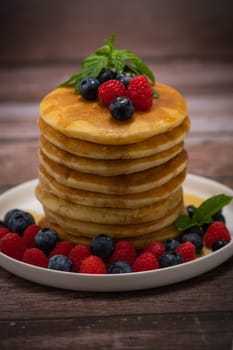 Recipe for maple syrup pancakes with raspberry and blueberry filling, High quality photo