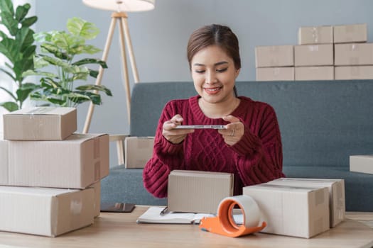 Woman taking a photo of product with a mobile phone for Identity verification or order confirmation, Business style for working at home, Working at home and owning businesses.