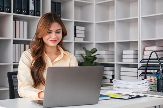 Asian woman working laptop. Business woman busy working on laptop computer at office.