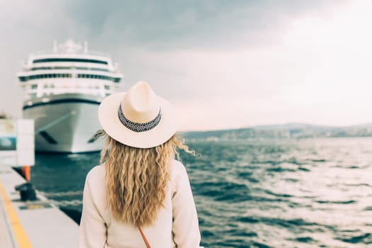Woman tourist standing in front of big cruise liner, travel female.