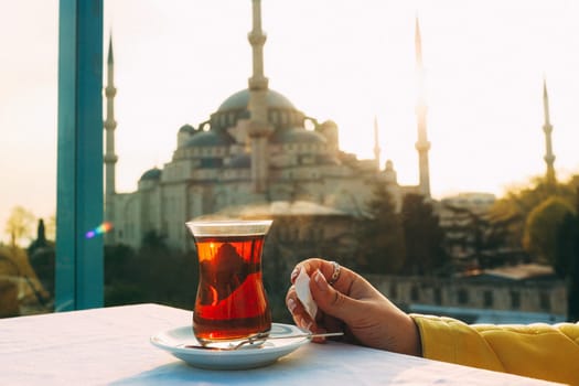 A glass of Turkish tea on the background of Hagia Sophia in Istanbul. High quality photo