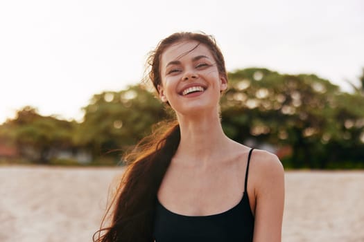 woman ocean smile enjoyment hair long sunset lifestyle vacation adult summer outdoor sea holiday coast walk caucasian beautiful running sand travel beach