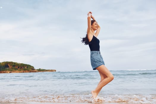 woman lifestyle beach long female travel running hair smile smiling water young sea space freedom person sand carefree copy summer sunset beautiful wave