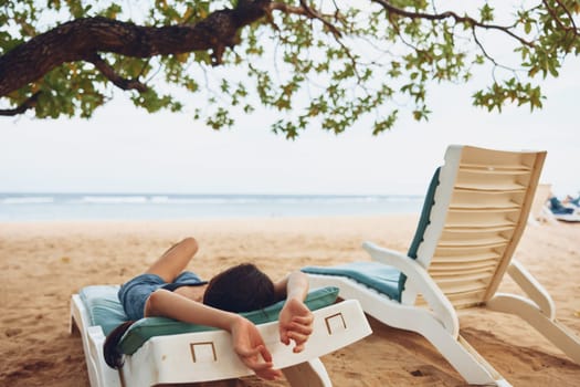 woman resting sea attractive resort ocean caucasian sunbed smiling enjoy lying sand female water hat girl young beach beautiful travel lifestyle