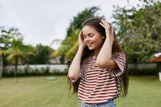 woman black sunny park beautiful walk grass face run t-shirt lifestyle young sun striped hipster nature joy smiling carefree summer freedom