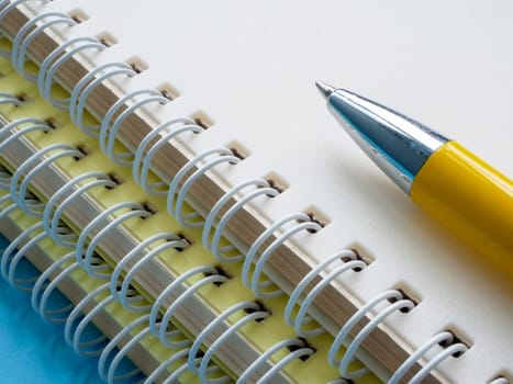 The pen lies on stack of notebooks as a concept of education.