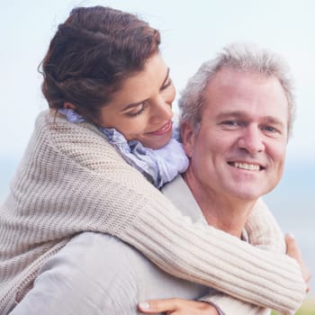 Happy and deeply in love. Portrait of a loving mature couple embracing and smiling happily