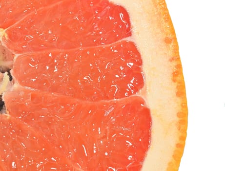 Close-up of a grapefruit slice on white background. Slice of ripe grapefruit. Close-up of fresh grapefruit slice on wite background. Macro horizontal image