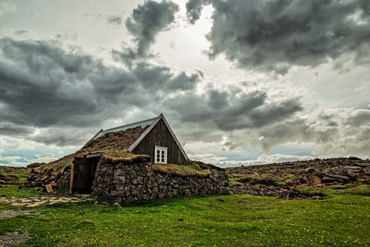 Icelandic traditional turf house at Hveravellir in a cloudy day, Iceland