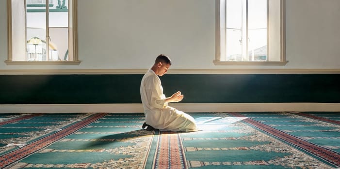 Muslim pray, hope or hands in prayer on carpet for peace, gratitude or support to Allah in holy temple or mosque. Trust, Islamic or spiritual person praying to worship God on Ramadan Kareem in Qatar.