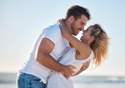 Couple, hug and love, happy at the beach with relationship and romance for bonding and together outdoor by the ocean. Romantic, care and travel date with man and woman hugging and quality time