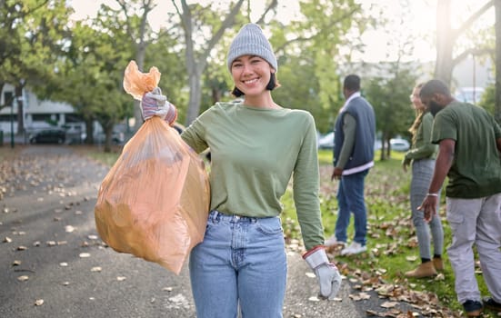 Plastic bag, park and happy woman in cleaning portrait for earth day, community service or volunteering support. Recycle, trash or garbage goals of ngo person helping in nature or forest pollution.