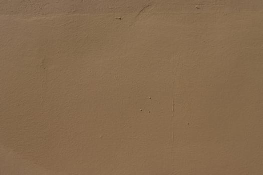 Old wall painted with brown paint. Texture of time-damaged paint. ..Texture for design with copy space.