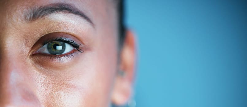 Eye, face and mockup with woman in portrait, vision and eye care with ophthalmology isolated on blue background. Eyebrow, future and perception, contact lens and lashes, awareness and focus in studio.