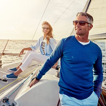 Mature, happy couple or retirement sailing yacht on ocean, sea or water relax holiday, wealth vacation or success summer. Smile, man or woman on luxury boat in investment, travel or freedom adventure.