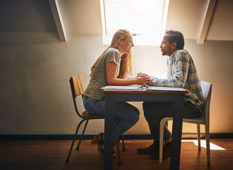 Holding hands, love and couple on table at restaurant, laughing at funny joke and bonding. Valentines day, romance diversity and affection, passion or care of man and woman enjoying date time at cafe.