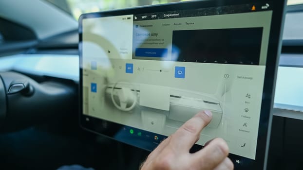 Caucasian man drives a modern electric car on a digital screen