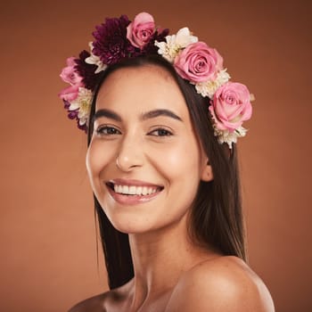 Woman, beauty smile and flower headband for spring portrait. Young happy girl, natural cosmetic makeup and healthy facial skincare wellness glow with floral rose band in orange background studio.